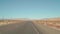 POV driving along empty highway in Nevada Desert on clear day