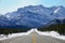 POV: Driving along a road offering a stunning view of the Canadian Rockies