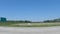 POV driving street pan distant water tower clear blue sky seen from interstate 95