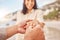 Pov, engagement and woman with ring on hand at beach with smile, love and happy couple vacation. Man, woman and jewelry