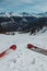 Pov or firts person view of red skis and beautiful mountain range in the background visible on a ski slope in france