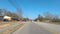 POV FPV Driving rear view of traffic coming towards people walking on the sidewalk