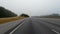 POV FPV rear view driving on the interstate I-20 distant traffic passing old white car