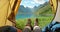 POV of a hiker or tourist camping on a field with nature view landscape on a beautiful sunny day with a lake, mountain