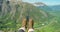 POV of a hiker or tourist sitting on mountain with nature view landscape on a beautiful sunny day while recording on a