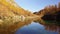 POV looking at lake near wood, tres and snowy mounts.Sunny autumn day Hiking in colorful red forest wild nature mountain