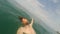 POV of man with beard swimming and in sea water on sunny day with action camera Summertime