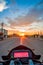 POV Motorbike Speedometer Against The Setting Sun on the Highway