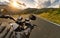 POV of motorbiker holding steering bar, riding in Alps