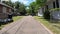POV narrow paved road beautiful vintage homes in Florida