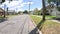 POV quiet paved road beautiful vintage homes in Florida cloudy blue sky