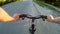 POV Road cyclist on asphalt road at sunset