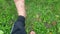 POV shot of an adult in barefoot, feet swaying back and forth, grass in the background.