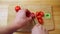 POV shot European male hands chopping fresh natural red tomatoes using knife