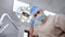 POV shot male dentist adjusting light lamp for teeth medical examination at clinic