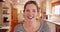 POV shot of woman video calling, smiling and talking to camera inside kitchen