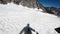 POV ski tourer skiing down the mountain on a sunny winter day
