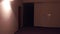 POV steadicam walk through generic hotel corridor. Automatic turning on of the light. 4K clip