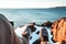 POV view of legs and shoes on background of snow rock and ocean. Brave explorer sits in front of snowy cliff and look on feet