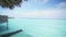 POV view: Luxury overwater villa in the Maldives. Rope hammock above ocean Water.