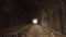 Pov walking inside of old dark long abandoned tunnel with bright light in the end.
