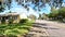 POV walking sidewalk beautiful landscaping clear sunny day in Florida