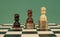 Poverty, wealth and income inequality concept. Black, brown and white pawns standing on stacks of coins