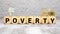 Poverty word written on wood block. Poverty text on wooden table for your desing, concept