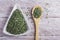 Powder and moringa leaves in bowl