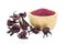 Powder of Roselle flower buds in wooden bowl on white background