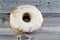 Powdered icing sugar ring donut, A glazed, yeast raised, American style ring doughnut with topping