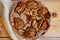 A powdered pear pie decorated with white cloth, dried orange, walnuts, anise stars and spoon on the wooden board