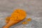 Powdered Turmeric on a Wooden Spoon, with a Shallow Depth of Field