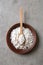 Powdered white sugar with stevia pills in bowl on grey table