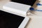 Power bank charges cell phone and tablet on desk