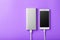 Power Bank charges your smartphone on a purple background. Universal external battery for gadgets free space and minimalistic