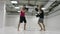 Power blow to boxing paw. Strong tattooed athlete in sports clothing training on boxing paws with partner