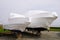 Power boat parked water protected by plastic film for wintering New boats in cover casing shrink wrap on sailboat stored for