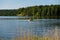 Power boat with people floating on the pond in the countryside in summer.