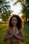 The power of breathing and meditation. Young calm mixed race woman with closed eyes keeping palms together and