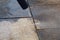 Power cleaning dirty floor, paving slabs with high pressure water jet