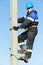 Power electrician lineman at work on pole