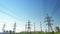 A power energy lines of high-voltage transmission pylons with heat and power plant and clear blue sky. Illustration of a