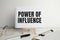 power of influence, text on white paper on the light background with charts paper