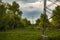 Power line corridor passing through the dense, green landscape and woods surrounding Oresje lake, Croatia