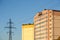 Power line pylon near multi-story residential building