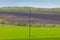 Power line towers. High voltage power line in a field under a blue sky. Landscape