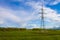 Power line towers. High voltage power line in a field under a blue sky. Landscape
