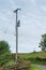 Power line with wooden poles on a green field