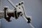 Power lines frozen by a large layer of ice layer in the shape of a cylinder with icicles. icing burdens the poles, ladder and ligh